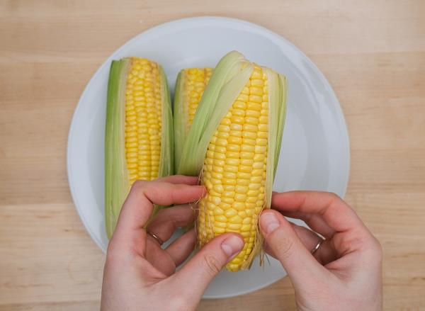 shucking corn on the cob