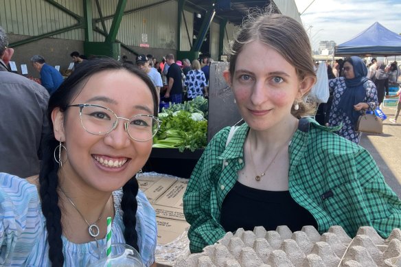 Millie Muroi and her flatmate Talica Gummery, holding a tray of more eggs than they know what to do with.